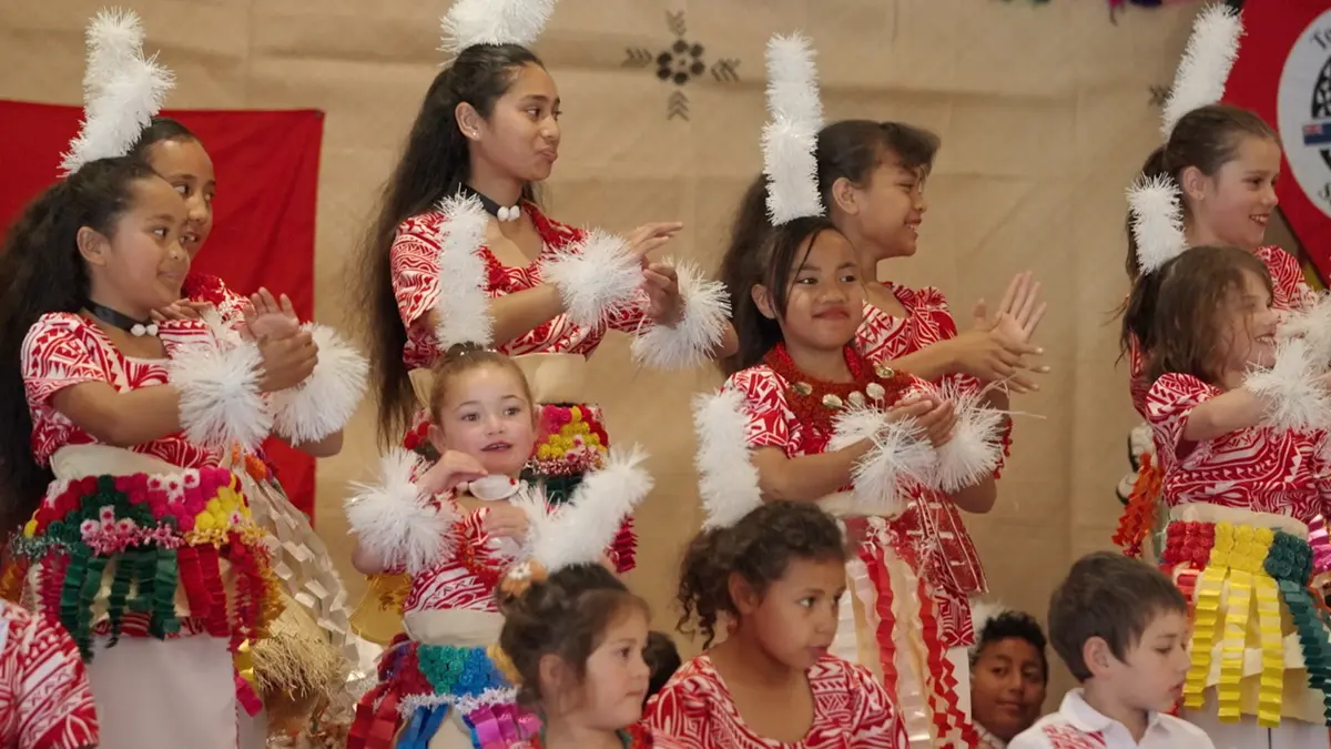 Group of children dancing in traditional Tongan outfits