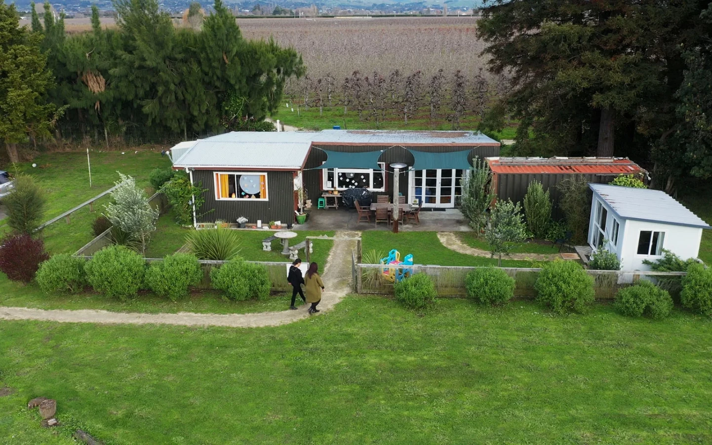Aerial view of the Mamia buildings surrounded by trees and grass.