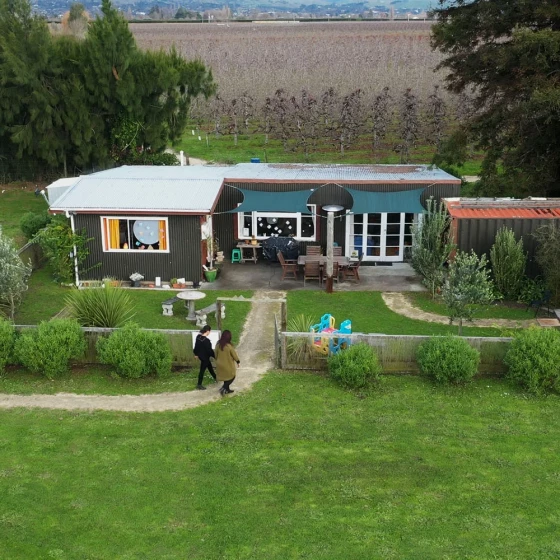 Aerial view of the Mamia buildings surrounded by trees and grass.