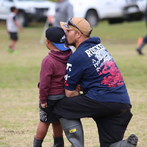 Father and son at rugby game.