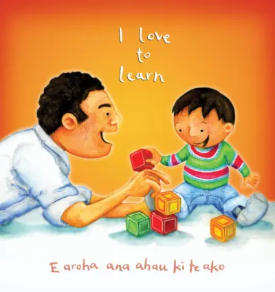 A father and toddler sit face to face playing with building blocks together. Text reads: "I love to learn / E aroha ana ahau ki te ako."