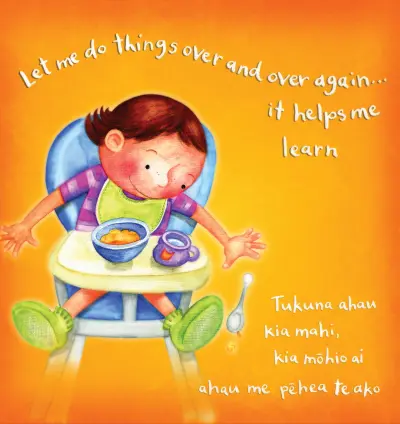 A toddler sits in a high chair with food and drink in front of them. They drop their spoon onto the ground. Text reads: "Let me do things over and over again… it helps me learn / Tukuna ahau kia mahi, kia mōhio ai ahau me pēhea te ako."